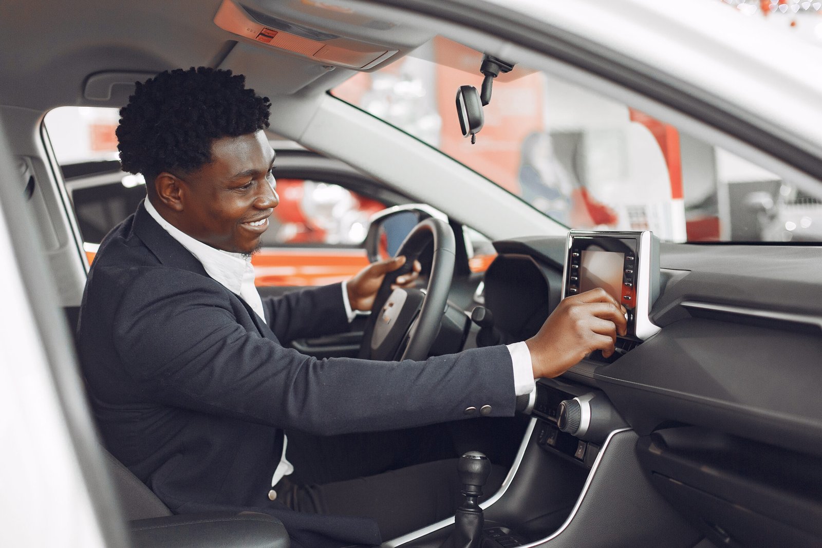handsome and elegant black man in a car salon